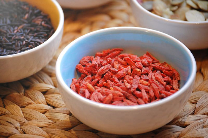Dried orange-red berries in a ceramic bowl